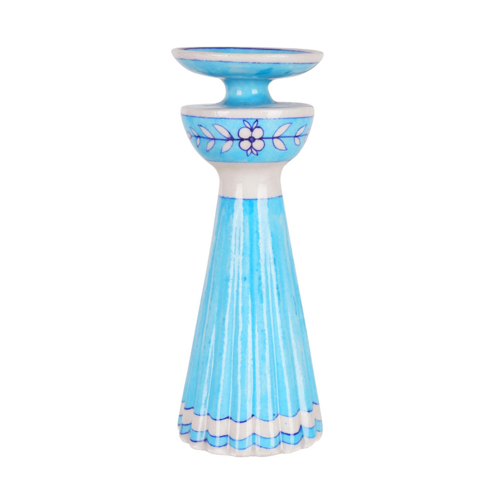 Blue candle holder with floral design on a white background