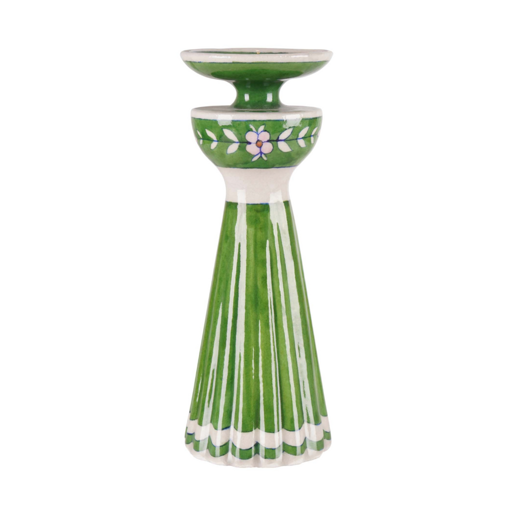 Green ceramic candle holder with floral design on a white background