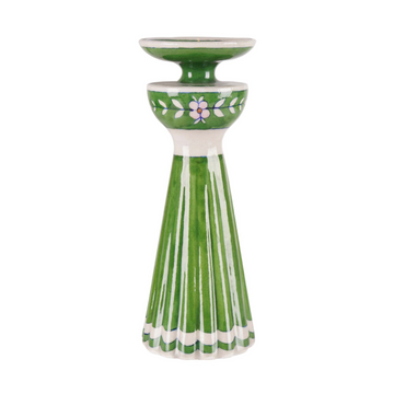 Green ceramic candle holder with floral design on a white background