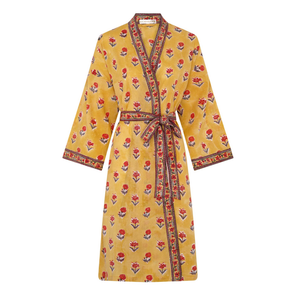 A yellow dressing robe with red floral print and a belt tied at the waist.
