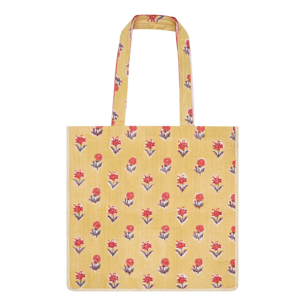 A cotton block-printed tote bag with contrast trim and a yellow and red floral design