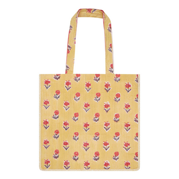 A cotton block-printed tote bag with contrast trim and a yellow and red floral design