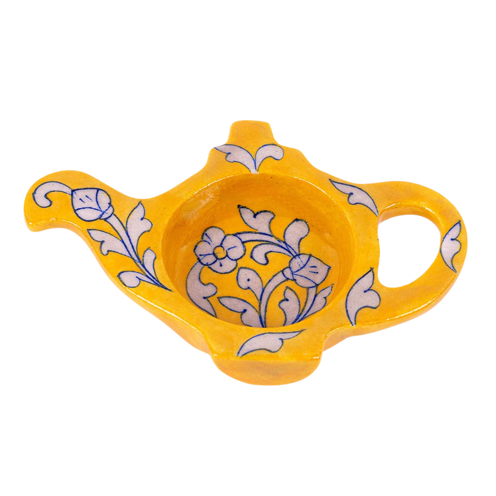 A yellow and white floral vine-patterned Jaipur Blue Pottery tea bag holder shaped like a teapot.