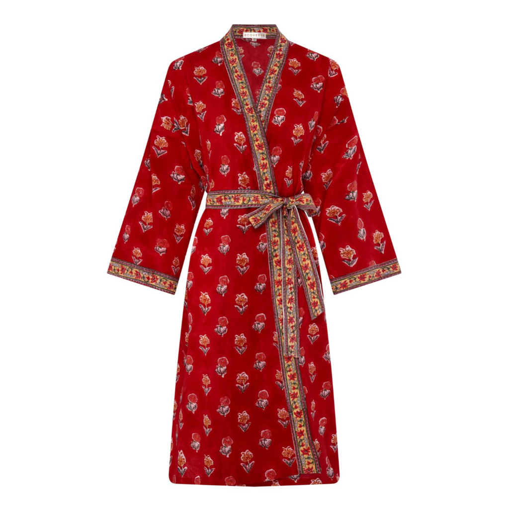 A red dressing robe with floral hand block print and a belt tied at the waist.