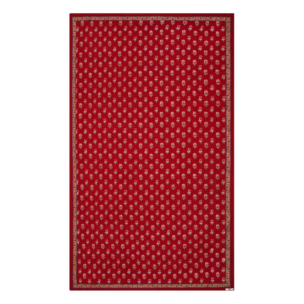 A red floral block printed tablecloth with a border