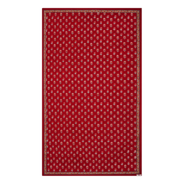 A red floral block printed tablecloth with a border