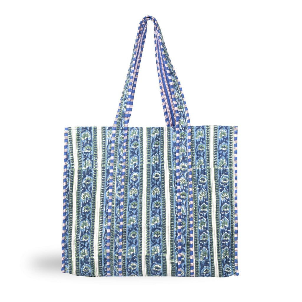 A stylish printed cotton tote bag with a striped botanical design and contrast trim in blues and greens