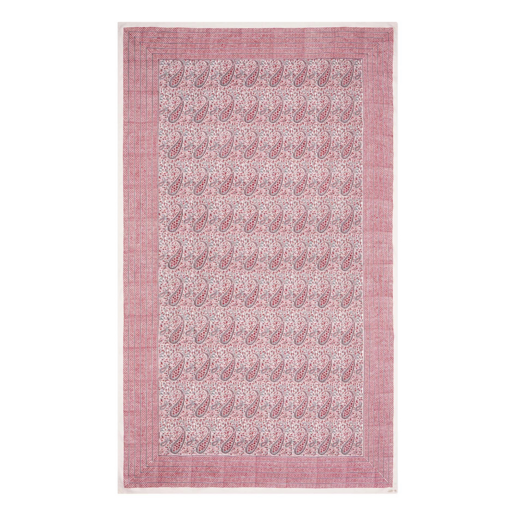 Pink block printed tablecloth with paisley pattern on a white background