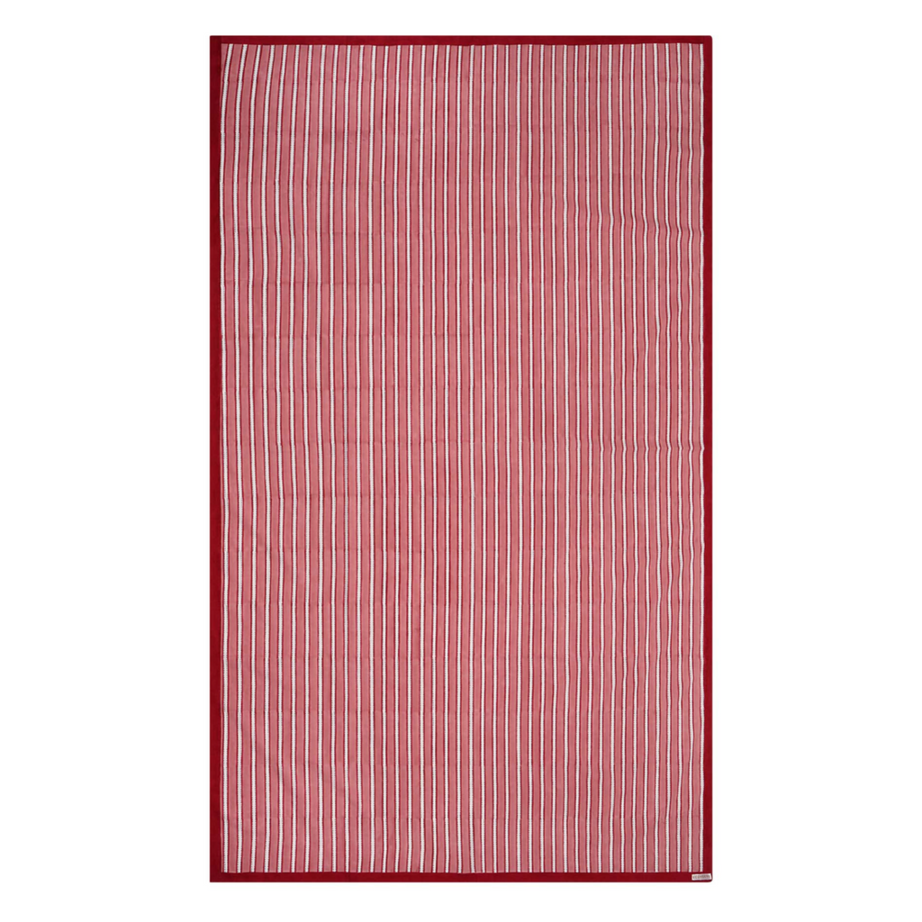 Red and white striped block printed tablecloth on a white background