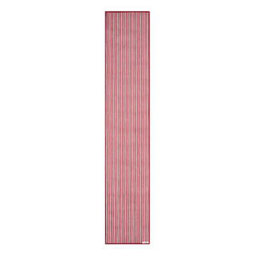A striped cotton table runner with a classic design, predominantly in red and white colors, displayed on a table.