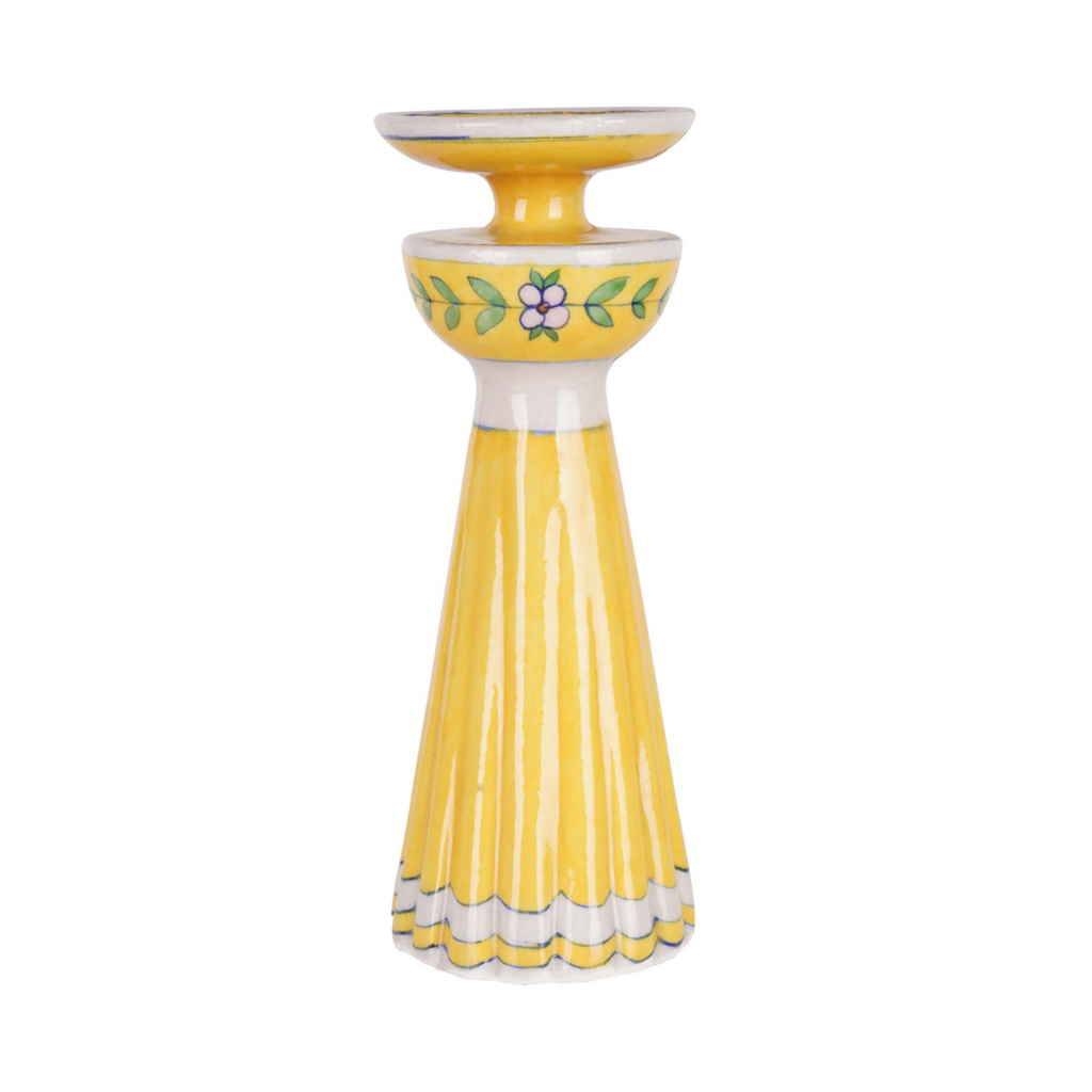 Yellow candle holder with floral design on a white background