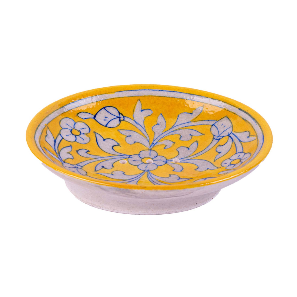 Ceramic soap dish with floral design on a yellow background